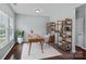 Bright home office with hardwood floors, large window, wooden desk, and decorative shelving unit at 321 Almora Loop, Mooresville, NC 28115