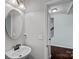 Stylish powder room featuring a pedestal sink with a decorative mirror and modern lighting at 321 Almora Loop, Mooresville, NC 28115
