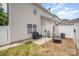 View of the backyard showing the patio, white vinyl fence, and AC unit outside this cozy home at 3561 Calpella Ct, Charlotte, NC 28262