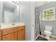 Bright bathroom featuring a wood vanity with a white countertop and a shower with a patterned gray curtain at 3561 Calpella Ct, Charlotte, NC 28262