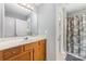 Bright bathroom features a large mirror, single sink vanity, and shower-tub combo at 3561 Calpella Ct, Charlotte, NC 28262