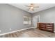 Bedroom with dresser, wood floors, and natural light from the window at 3561 Calpella Ct, Charlotte, NC 28262