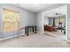 Open bonus room with neutral carpet, window with blinds, and adjacent living space at 3561 Calpella Ct, Charlotte, NC 28262