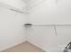 Walk-in closet with wire shelving, neutral carpet, and ample storage space at 3561 Calpella Ct, Charlotte, NC 28262