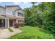 Inviting two-story townhouse with green lawn and natural backdrop at 3561 Calpella Ct, Charlotte, NC 28262