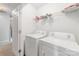 Bright laundry room featuring white washer and dryer units, offering a functional space for laundry needs at 3561 Calpella Ct, Charlotte, NC 28262