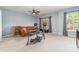 Living room with weights, ceiling fan, leather sofa, window with curtains, and neutral carpet at 3561 Calpella Ct, Charlotte, NC 28262