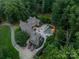 Expansive aerial view of estate showcasing custom pool, backyard patio, and lush surrounding greenery at 3587 Ridgetop Rd, Sherrills Ford, NC 28673