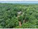 Estate aerial view surrounded by mature trees on a large lot providing privacy and a serene setting at 3587 Ridgetop Rd, Sherrills Ford, NC 28673