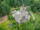 Aerial view of custom home featuring an inground pool, jacuzzi, patio and lush landscaping at 3587 Ridgetop Rd, Sherrills Ford, NC 28673