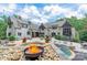Stunning backyard featuring a stone patio with a fire pit, swimming pool, lounge chairs, and outdoor seating at 3587 Ridgetop Rd, Sherrills Ford, NC 28673