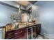 Granite-topped bar area with a wine refrigerator and decorative lighting fixtures at 3587 Ridgetop Rd, Sherrills Ford, NC 28673