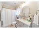 Well-lit bathroom with a shower/tub, a mirror, and a single sink vanity at 3587 Ridgetop Rd, Sherrills Ford, NC 28673