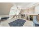 Bright bonus room featuring high ceilings, unique lighting, and cozy blue furnishings at 3587 Ridgetop Rd, Sherrills Ford, NC 28673