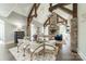 Living and Dining Area featuring vaulted ceilings, exposed wooden beams, and a stone fireplace at 3587 Ridgetop Rd, Sherrills Ford, NC 28673