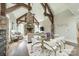 Open living room with stone fireplace, exposed beams, hardwood floors, and glass table for an inviting space at 3587 Ridgetop Rd, Sherrills Ford, NC 28673
