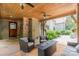 Covered outdoor patio with stone fireplace, wood ceiling, ceiling fans, and comfortable seating at 3587 Ridgetop Rd, Sherrills Ford, NC 28673