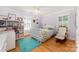 Comfortable bedroom with natural light, hardwood floors, and a cozy reading nook at 408 Johnsfield Rd, Shelby, NC 28150