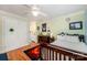 Well-lit bedroom featuring wood floors, a ceiling fan, and closet with shamrock decoration at 408 Johnsfield Rd, Shelby, NC 28150