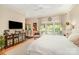 Bright bedroom featuring a king size bed, a large TV, and outdoor access to a private balcony at 408 Johnsfield Rd, Shelby, NC 28150