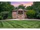 Stately brick home with manicured lawn and grand entrance exudes timeless elegance at 408 Johnsfield Rd, Shelby, NC 28150