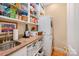 Functional laundry area with granite counters and stacked washer and dryer at 408 Johnsfield Rd, Shelby, NC 28150