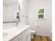 This bathroom features double sinks, white cabinets, and shower-tub combo at 4226 Acorn St, Charlotte, NC 28205