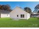 Well-maintained backyard with lush green lawn and the back of the house in view at 4230 Acorn St, Charlotte, NC 28205