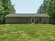 Expansive backyard with lush lawn and trees featuring a grey house with door, windows and grill at 429 Summer Ridge Dr, Stanley, NC 28164