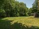 Expansive backyard featuring a well-maintained lawn and mature trees offering plenty of privacy at 429 Summer Ridge Dr, Stanley, NC 28164