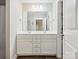 Bathroom with double sink vanity, white cabinets and a large mirror above at 429 Summer Ridge Dr, Stanley, NC 28164