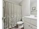 Cozy bathroom with a shower featuring floral curtain, neutral paint, with a stylish vanity and sink at 429 Summer Ridge Dr, Stanley, NC 28164