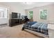 Neutral bedroom with large bed, television, desk work space with natural light from two sunny windows at 429 Summer Ridge Dr, Stanley, NC 28164