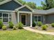 Close up of a front door and porch with meticulous landscaping around the property at 429 Summer Ridge Dr, Stanley, NC 28164