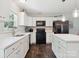 Bright kitchen featuring white cabinets, stainless steel appliances and hardwood floors at 429 Summer Ridge Dr, Stanley, NC 28164