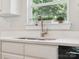 Bright kitchen features a stainless steel faucet, double bowl sink and quartz countertops with a large window overlooking greenery at 429 Summer Ridge Dr, Stanley, NC 28164