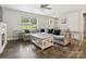Bright living room with large windows, a ceiling fan and hardwood floors at 429 Summer Ridge Dr, Stanley, NC 28164