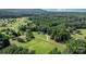 Aerial view of a well maintained property featuring mature trees and lawn areas at 4395 Burton Rd, Maiden, NC 28650