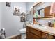 Cozy bathroom with a toilet, sink, vanity with storage, and decorative wall art and shelving at 4395 Burton Rd, Maiden, NC 28650