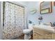 Bathroom featuring a toilet, sink, vanity with storage, and a shower with curtain at 4395 Burton Rd, Maiden, NC 28650