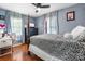 Comfortable bedroom with a large bed, side table, and natural light streaming in through two windows at 4395 Burton Rd, Maiden, NC 28650