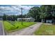 Scenic home exterior with a long driveway, spacious lawn, and mature trees at 4395 Burton Rd, Maiden, NC 28650