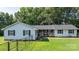 Charming ranch-style home with a stone porch, complemented by a lush green lawn and mature trees at 4395 Burton Rd, Maiden, NC 28650