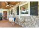 Cozy covered front porch with stone accents and charming decor at 4395 Burton Rd, Maiden, NC 28650