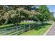 Inviting home exterior with a beautiful flowering tree and white picket fence at 4395 Burton Rd, Maiden, NC 28650