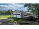 View of the two-car garage with black truck under carport, and fenced yard at 4395 Burton Rd, Maiden, NC 28650