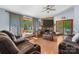 Spacious living room featuring a stone fireplace, large windows, and plush seating at 4395 Burton Rd, Maiden, NC 28650