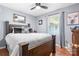 Comfortable main bedroom with dark wood furniture, decorative pillows, and a serene atmosphere at 4395 Burton Rd, Maiden, NC 28650