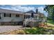Rear exterior of home featuring a spacious deck with stairs leading to the backyard at 4395 Burton Rd, Maiden, NC 28650
