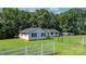 Back exterior view of the home and trailer, with a fenced backyard and green lawn at 4395 Burton Rd, Maiden, NC 28650
